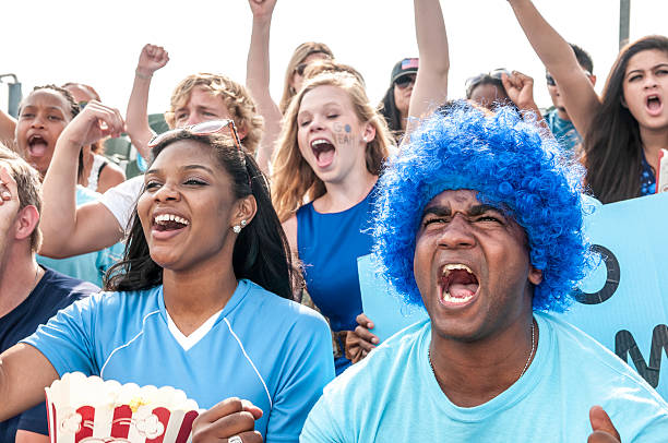 istock Fans with raised arms cheering for their team 187089931