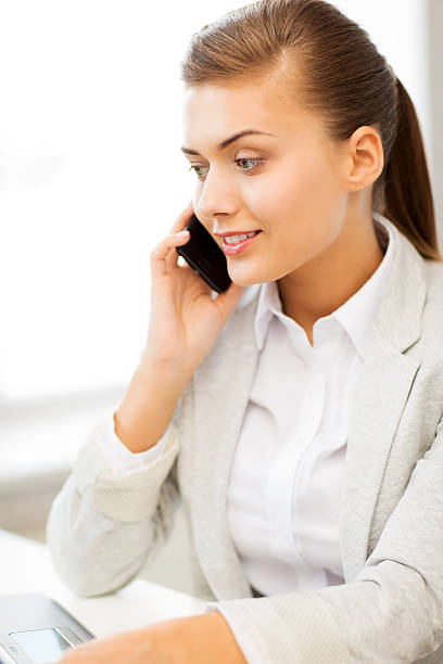 istock businesswoman with smartphone in office 187090235