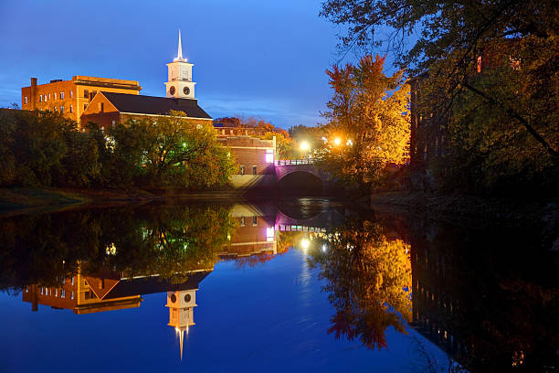 Nashua, New Hampshire Downtown Nashua, New Hamshire refection along the banks of the Nashua River on a calm night. Nashua is the second largest city in the state of New Hampshire. Nashua is known for its  livability and economic expansion as part of the Boston region nashua new hampshire stock pictures, royalty-free photos & images