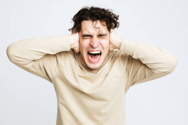 istock Young handsome man hold hands on temples ears, emotion and stress 1870914050