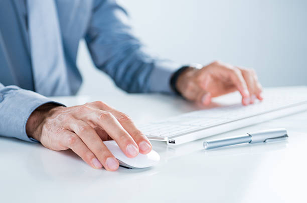 Businessman Using Computer Close Up Of Businessman Using Computer At Desk In Office netbook stock pictures, royalty-free photos & images