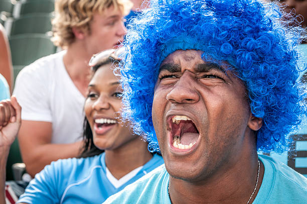 istock Fans with raised arms cheering for their team 187092241