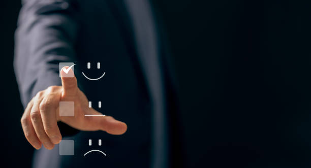istock Customer satisfaction concept. Hand with touching Positive emotion happy smile face icon screen with copy space, feedback, survey, standard quality. User give rating to service experience 1870923514