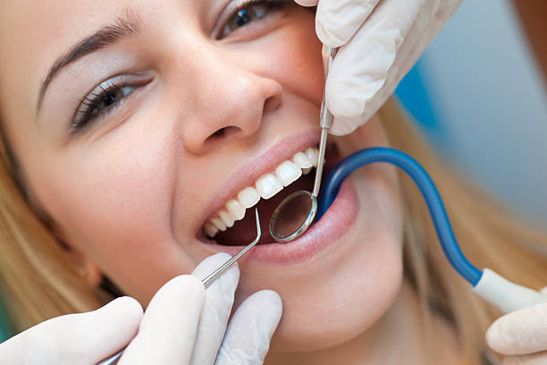 istock Young confident woman at dentist for routine checkup. 187092436