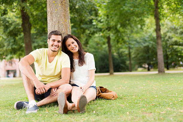 istock young people relaxing in the park 187092639