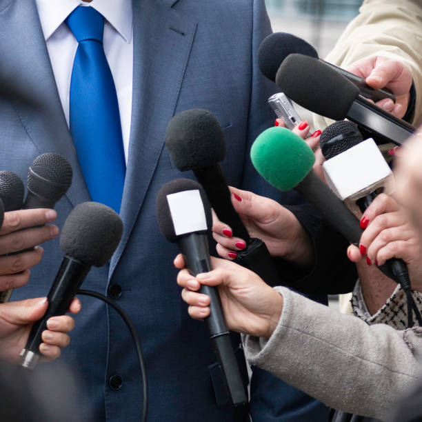 istock A man in a suit being interviewed by the media 187092713