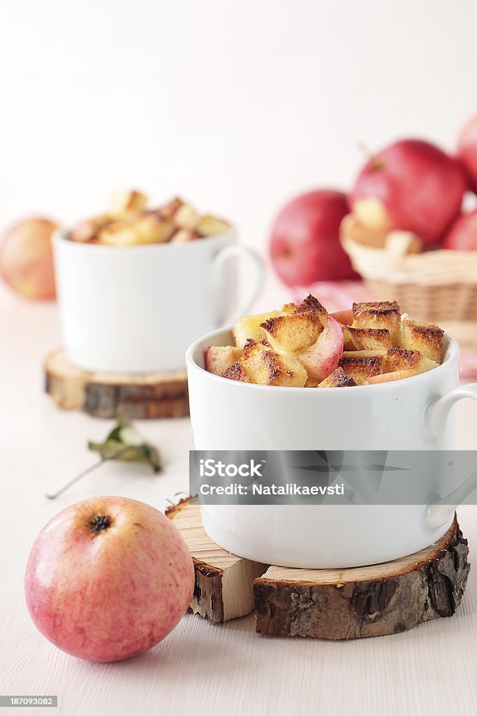 Two cup of wheat bread pudding with apples White bread pudding with apples and cinnamon in cups Apple - Fruit Stock Photo