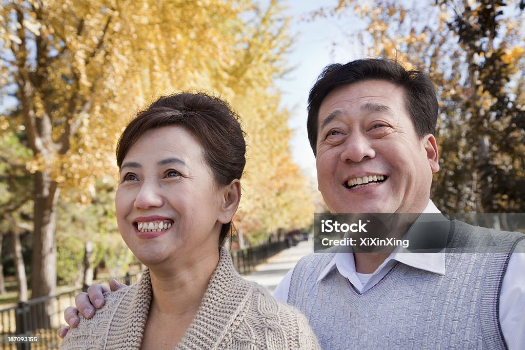 Happy Mature Couple Enjoying the Park in Autumn Chinese Ethnicity Stock Photo