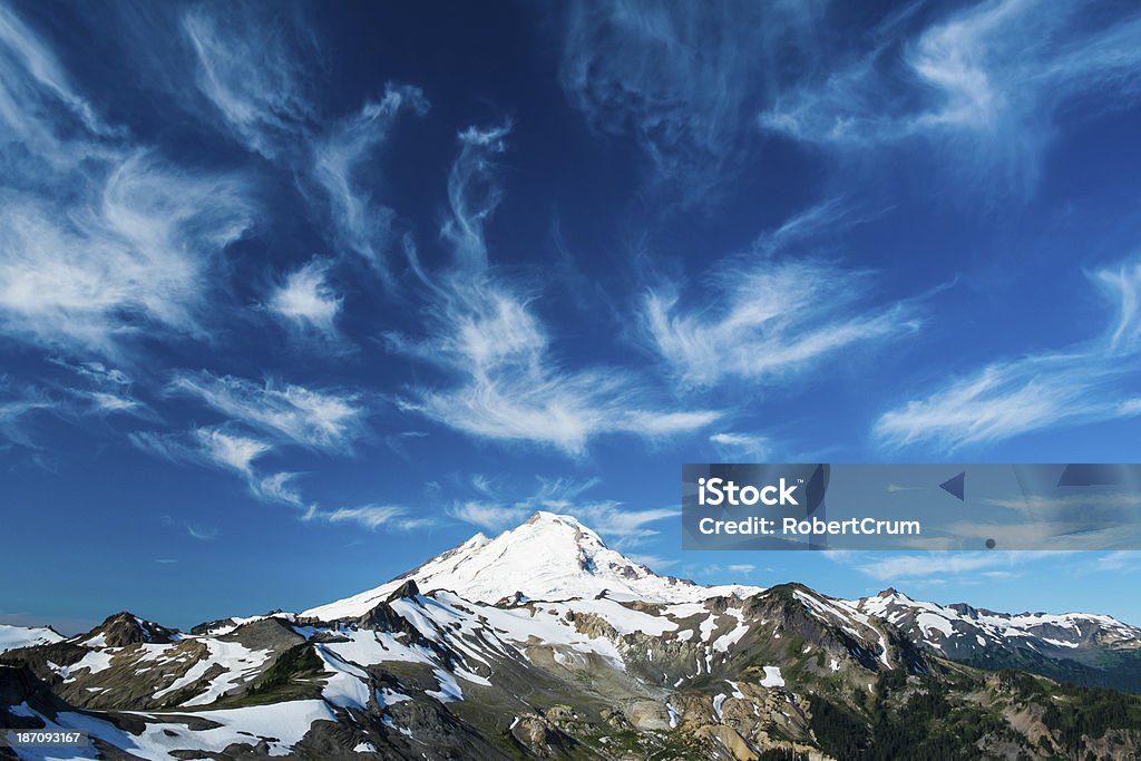 Snowcapped Mount Baker under high cirrus clouds Beautiful snowcapped Mount Baker under high cirrus clouds, Washington state Cascades Blue Stock Photo