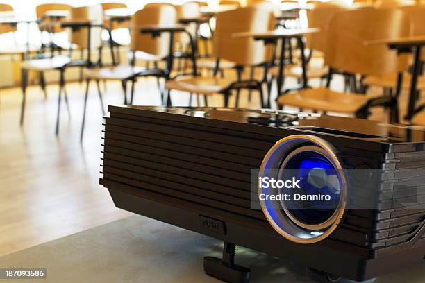 A Digital Projector In Front Of Desks In A Classroom Stock Photo - Download Image Now