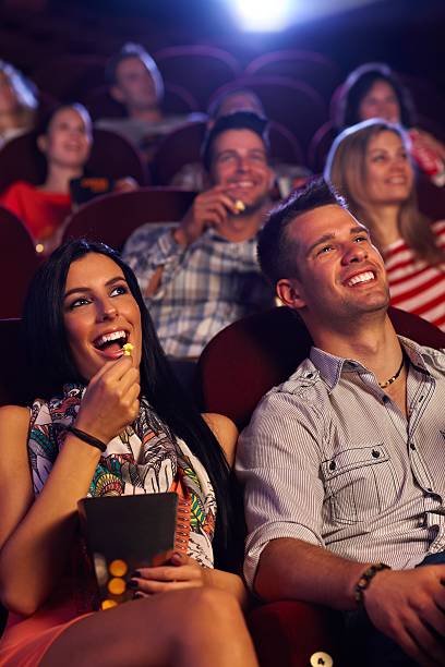 istock Young couple sitting in cinema smiling 187095697