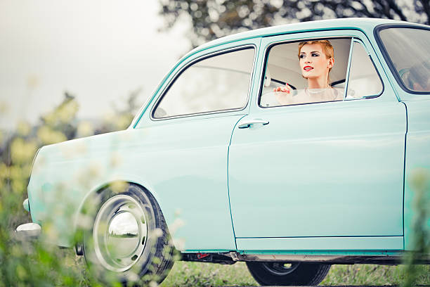 istock Young woman in a vintage car 187096397