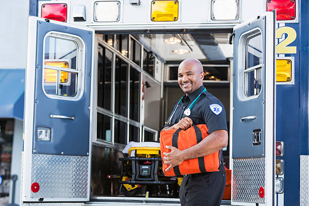 istock Paramedic standing by ambulance 187096894
