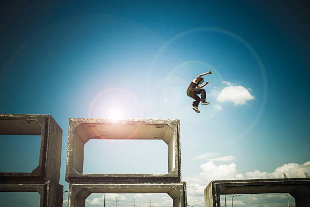 Man jumping At a urban landscape with a little post production for effect free running stock pictures, royalty-free photos & images