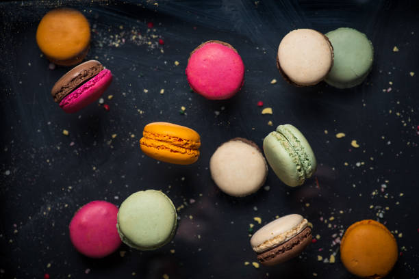 istock Multicolored french macaroons on dark background 1870975923
