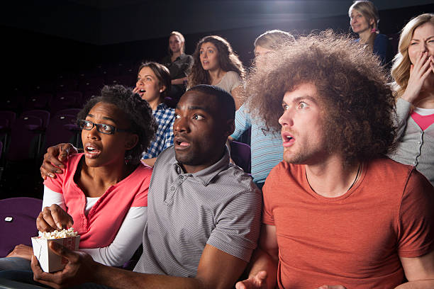 Teenagers in Cinema Teenagers in cinema, looking shocked. black men with blonde hair stock pictures, royalty-free photos & images