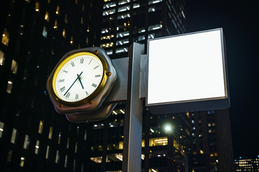 Retro style city signboard mockup with a Street Clock, Night shot, Midtown Manhattan, New York