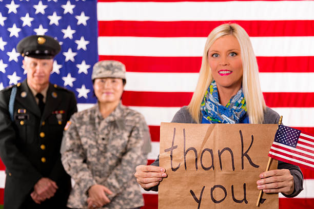 istock Military:  American woman shows support for local veterans. 187099464