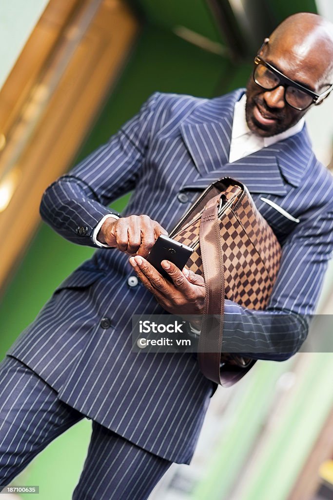 Smiling business man sending message Black businessman on the street sending message. 30-34 Years Stock Photo