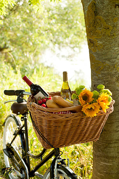 Picnic lunch packed in a bicycle basket Dutch style bike with picnic basket. bicycle basket stock pictures, royalty-free photos & images