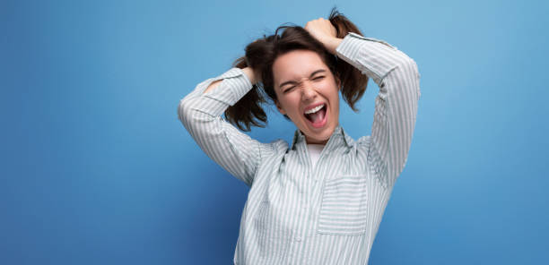 istock charming young brunette lady with thick hair makes a face and laughs 1871013197