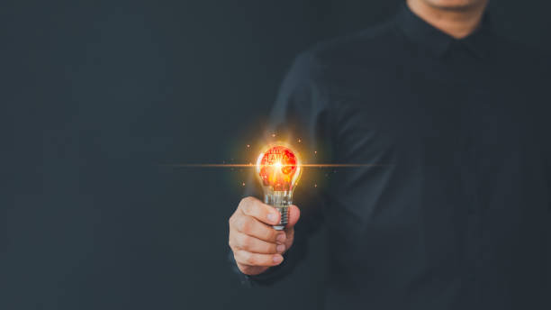 istock Male hand holding illuminated light bulb. Creative idea, new business plan, motivation, innovation, inspiration. Energy saving light bulb. Concept of new ideas with innovation and creativity. 1871024588