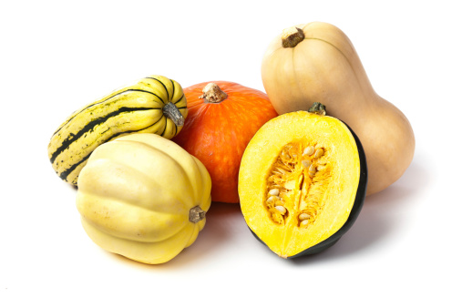 A variety of fall squashes, including Acorn,butternut, Amber Cup, and Carnival squash, isolated on white background.