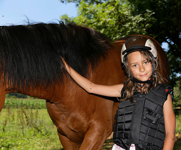istock little girl with her horse 187104189