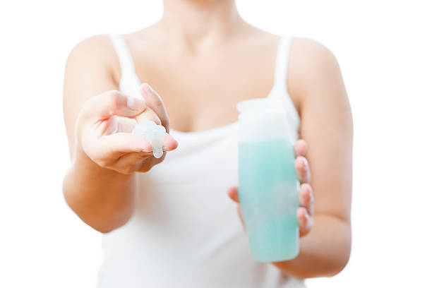 istock Bottle with cream in a female hand 187104222