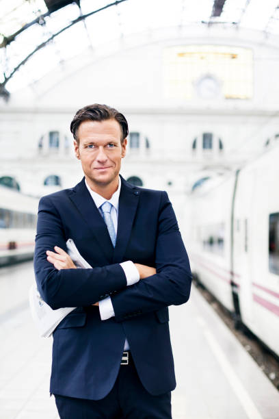 istock Businessman waiting at train station 187104365
