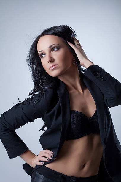 istock Stylishly dressed seductive girl posing in studio 187104420