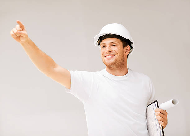 istock male architect looking at blueprint 187104479