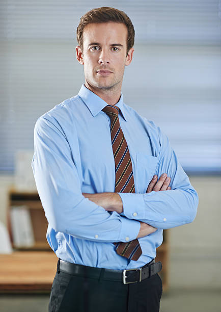 Portrait Of Businessman Gesturing Against White Background