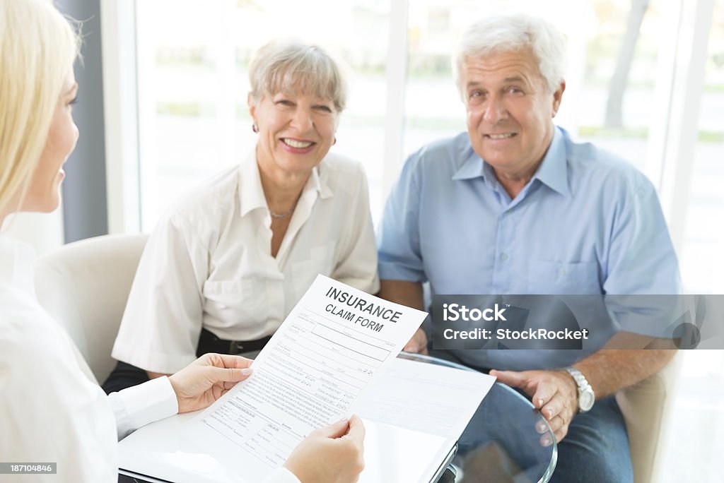 Buying insurance Senior couple at meeting with agent for the sale of insurance Insurance Agent Stock Photo