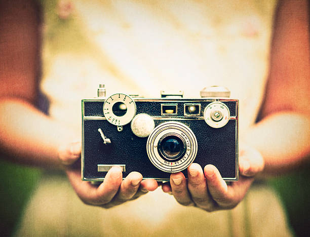 Young Girl Holding Vintage Camera