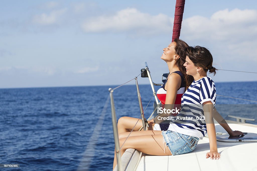 On the vacation! Happy women on the bow of a Sail Boat.Copy space 20-29 Years Stock Photo