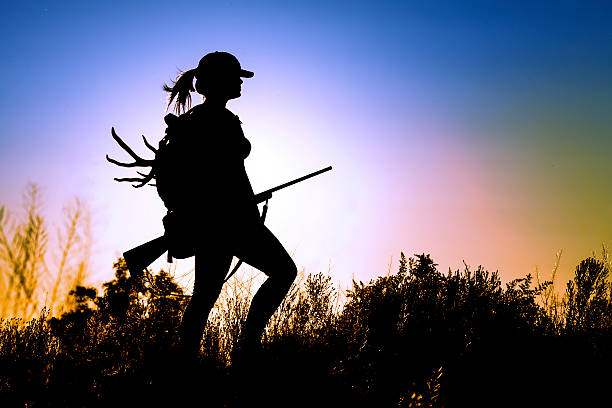 Young Lady Hunter young Lady on a Deer Hunt at sun sunset hunting stock pictures, royalty-free photos & images