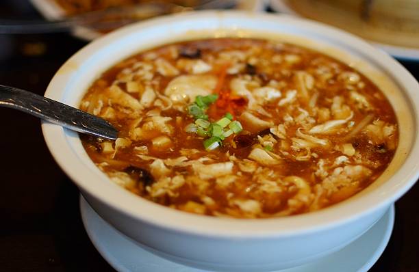 Hot and sour soup The classic Szechuan soup made with tofu, pork, bamboo shoots, chicken broth, vinegar, chili oil, beaten egg and dried mushrooms Hot and Sour Soup stock pictures, royalty-free photos & images