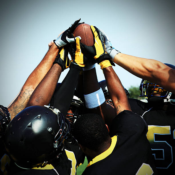 istock Football players celebrating touchdown 187107823