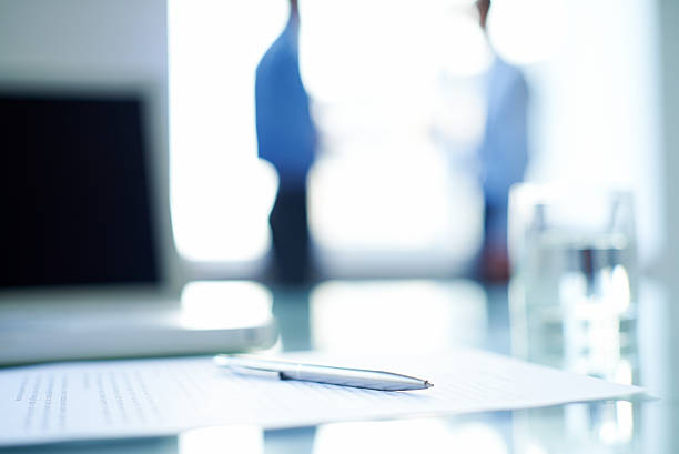 istock Pen across a business contract on office desk 187108136