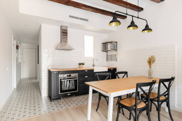 istock Elegant white kitchen with dining table and appliances 1871081626