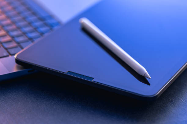istock Digital tablet, stylus pen and laptop on the desktop, close up. 1871082435