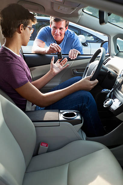 istock Father handing son car keys 187108311