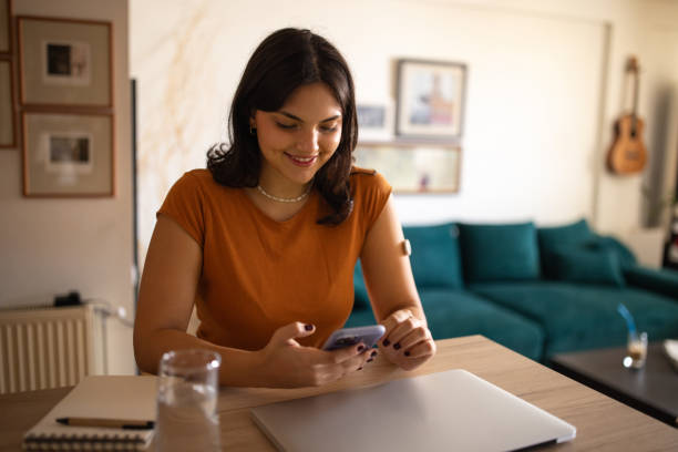 istock Young diabetic woman using phone 1871093105