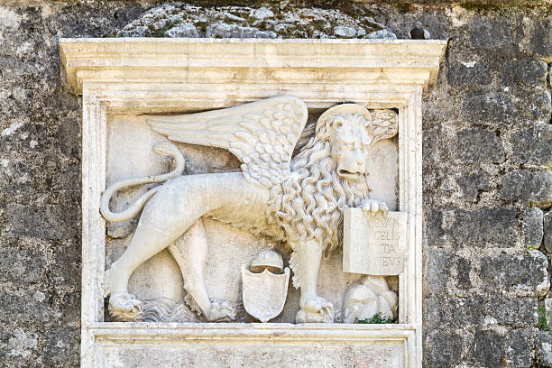 Relief sculpture of venetian winged lion, made from marble, placed on defending wall of town of Kotor, Montenegro