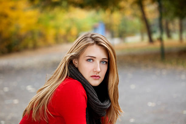 istock beautiful young woman in park 187110185