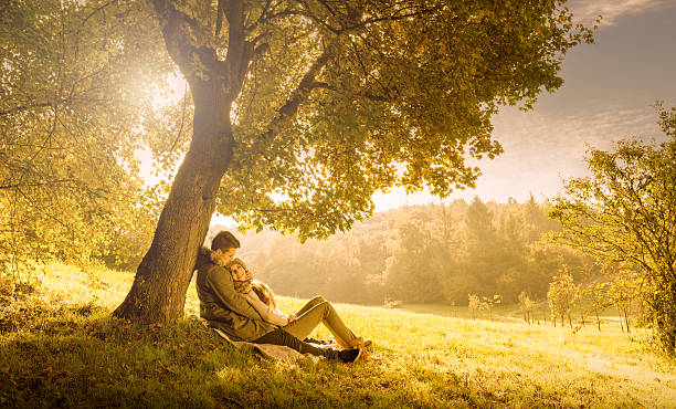 istock Loving couple under a big tree in the park ,autumn 187110514