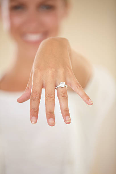 We're tying the knot Cropped shot of a young woman showing off her engagement ring ring jewelry photos stock pictures, royalty-free photos & images