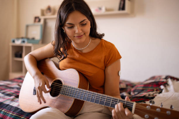 istock Young woman playing acoustic guitar 1871107171