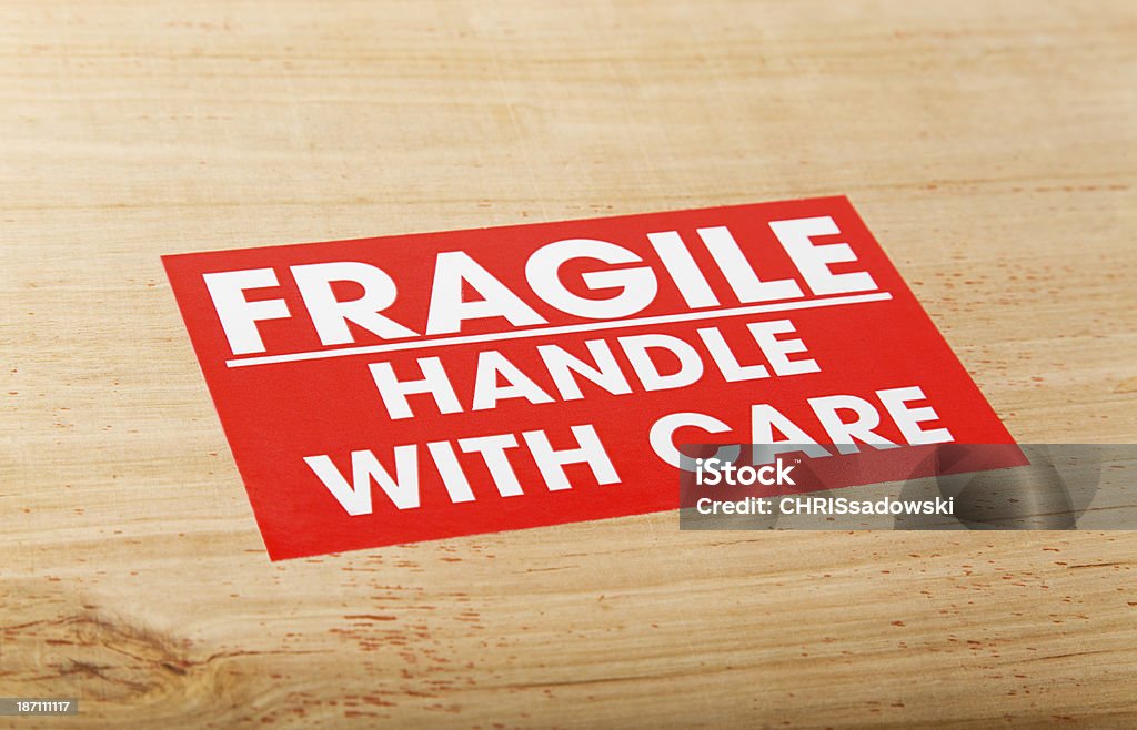 Fragile Package Fragile Package Sign on Wooden Crate. Handle with Care with Selective Focus Fragile Sign Stock Photo